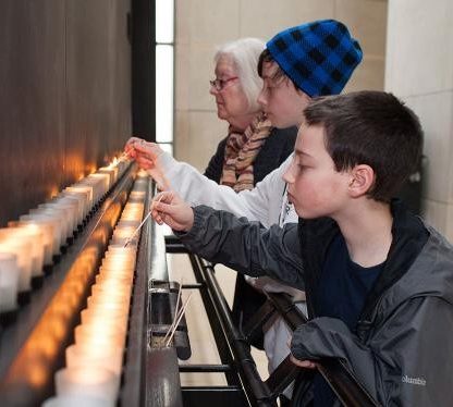 Lighting candles in remembrance at the United States Holocaust Memorial Museum, Washington DC, during Days of Remembrance, 2014.